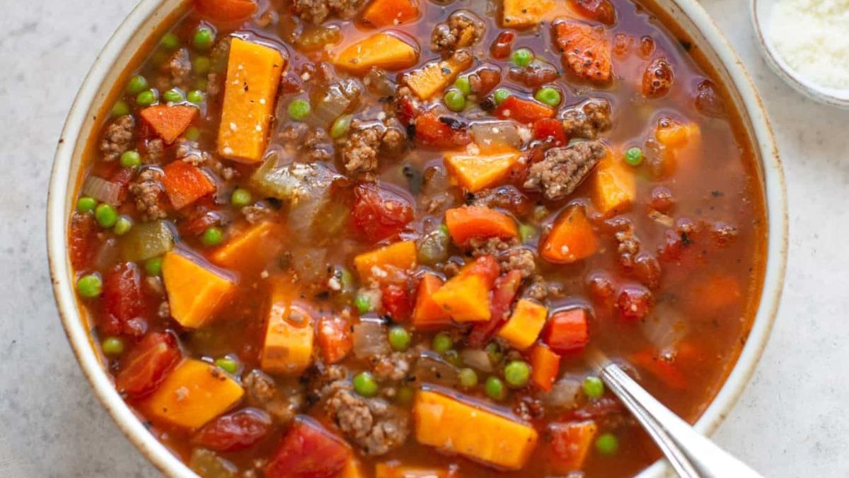 hamburger soup in a bowl with a spoon.