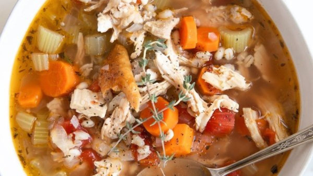 turkey soup with carrots in a bowl.