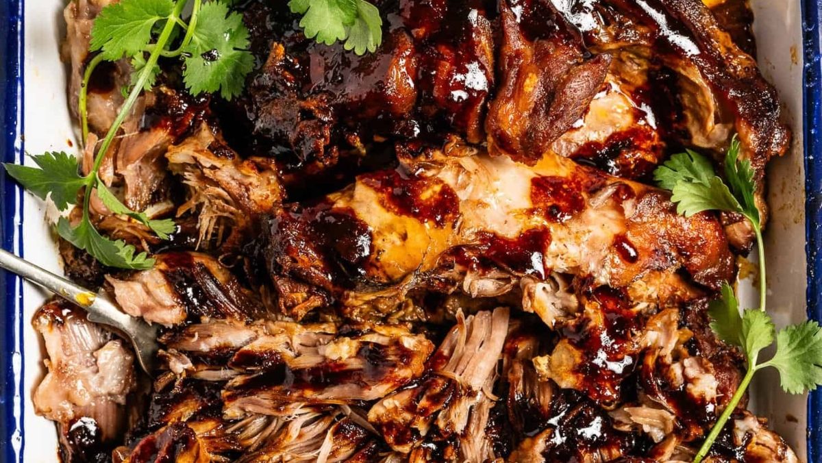 Pork tenderloin in a baking dish with sauce and cilantro, perfect for pork dinners.