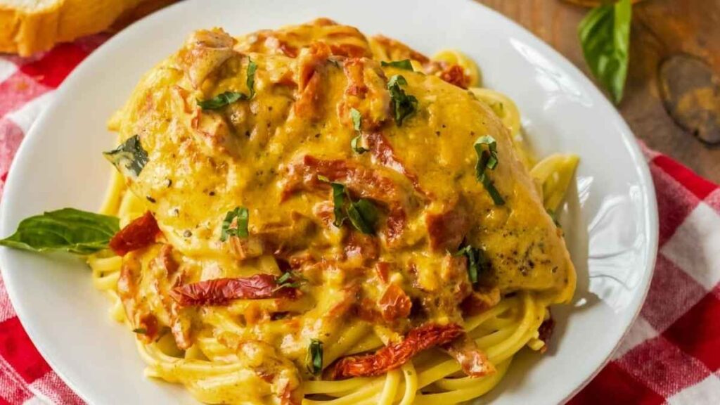 A savory plate of chicken and pasta, served with a delectable sauce.