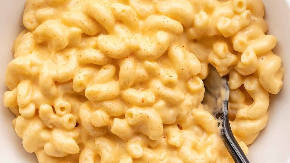 Macaroni and cheese, a delicious side dish, served in a white bowl.