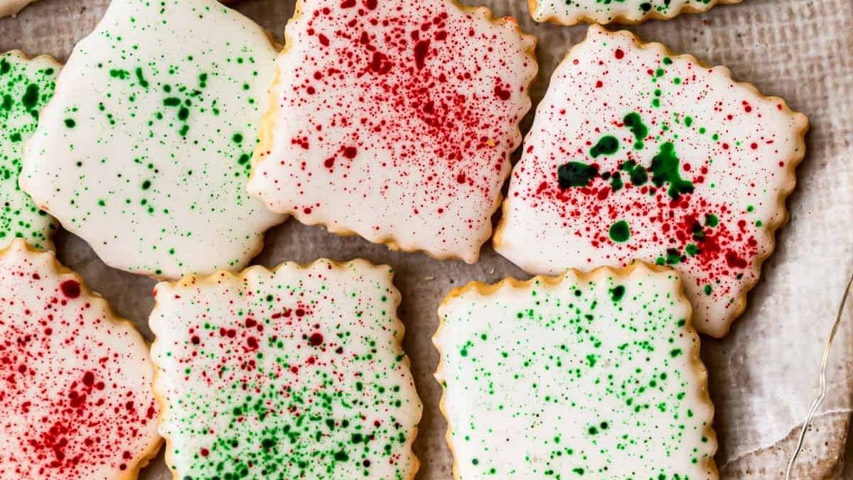 Christmas cookies with sprinkles on a piece of parchment paper.