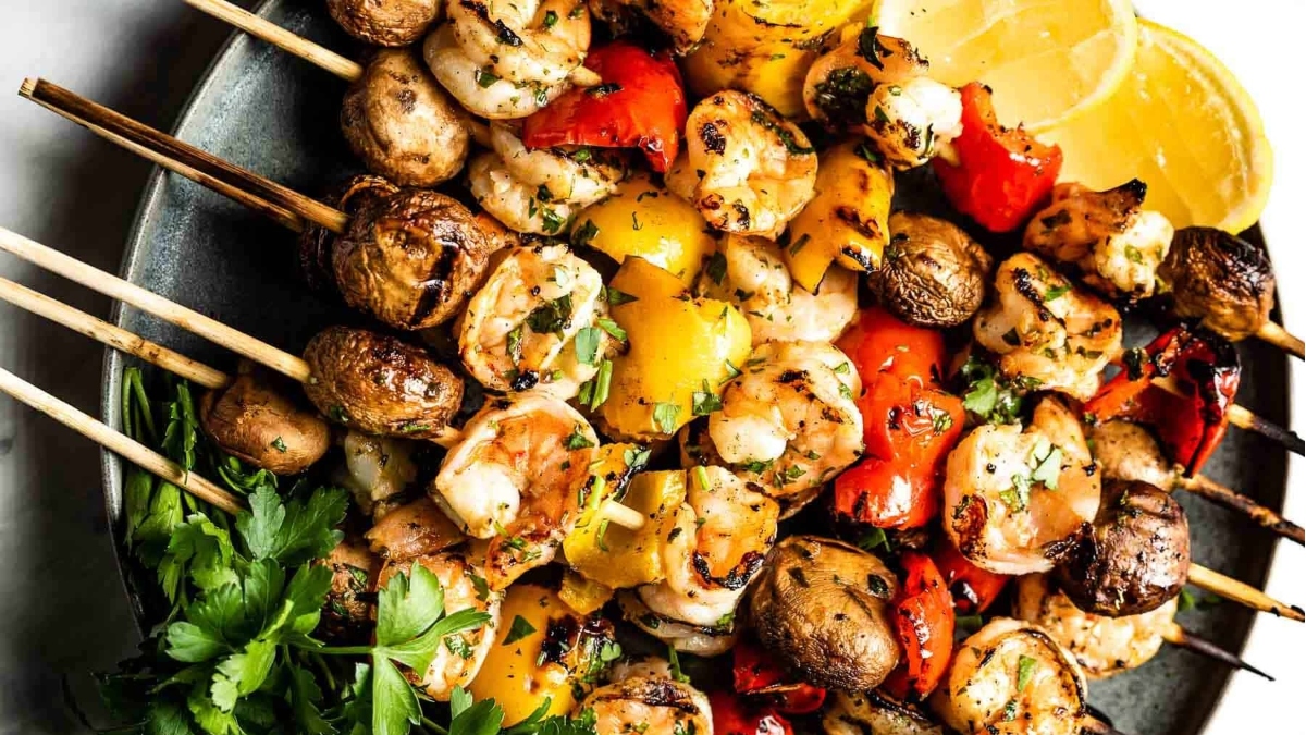 Shrimp dinner served on a plate with grilled skewers.