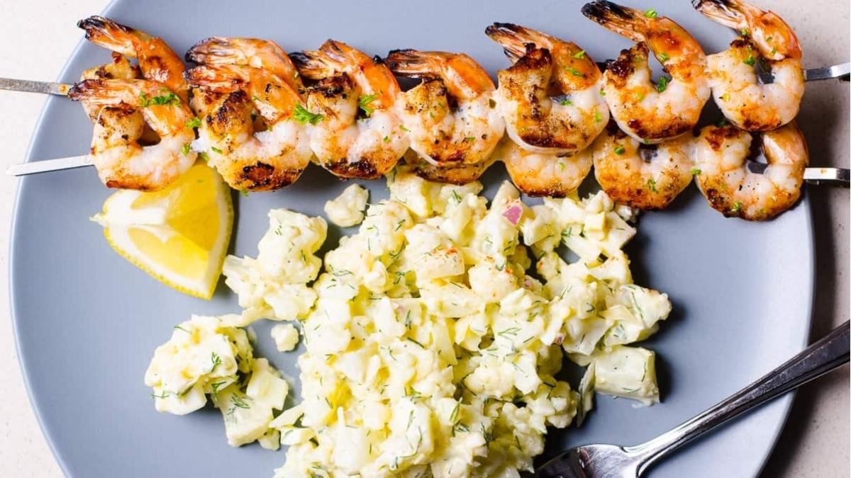 Shrimp skewers served with lemon wedges for dinner.