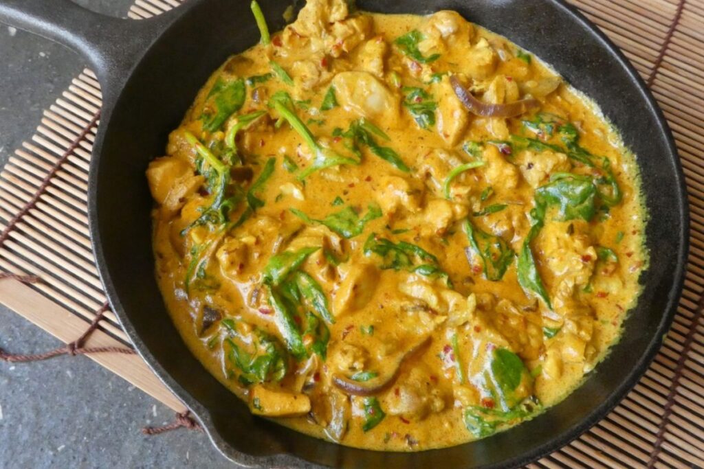 Indian chicken curry with coconut milk, spinach and turmeric. 